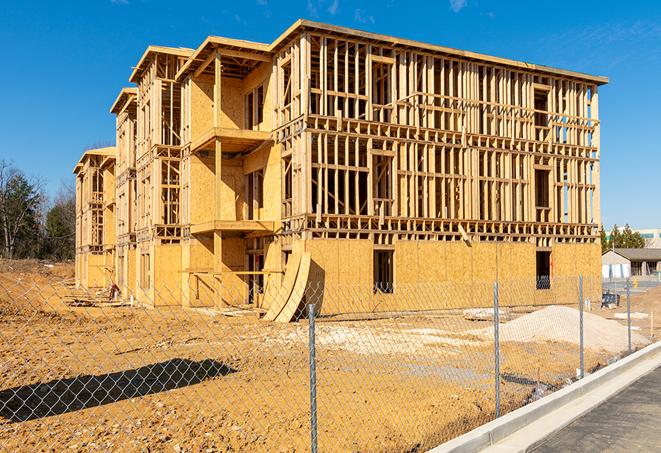 a job site enclosed by temporary chain link fences, ensuring safety for workers and pedestrians in Bear Creek